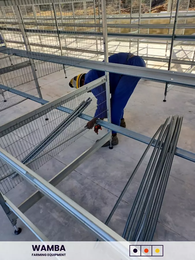 Workers assembling cage frames.
